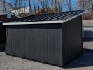 Rear of 10x14 lean-to storage shed in black LPSmartSide siding and standing seam metal roof in black